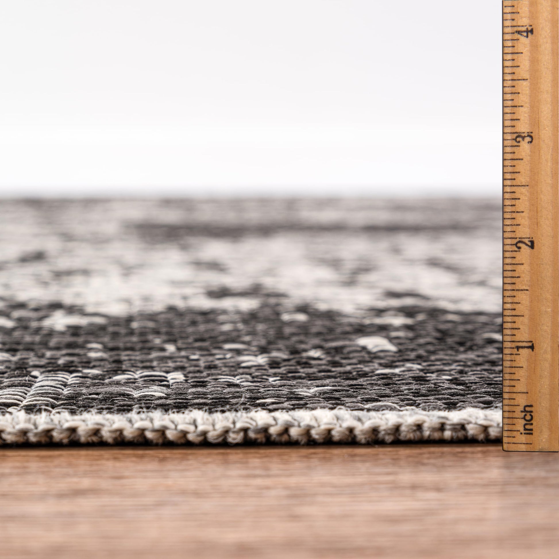 Bound edge detail of the Black modern abstract outdoor rug