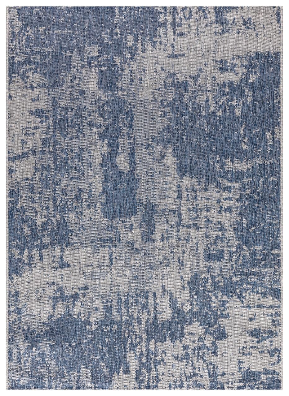 Navy and ivory modern abstract outdoor rug on covered teak patio