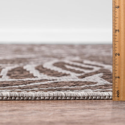Bound edge detail of the Brown tropical leaf outdoor rug