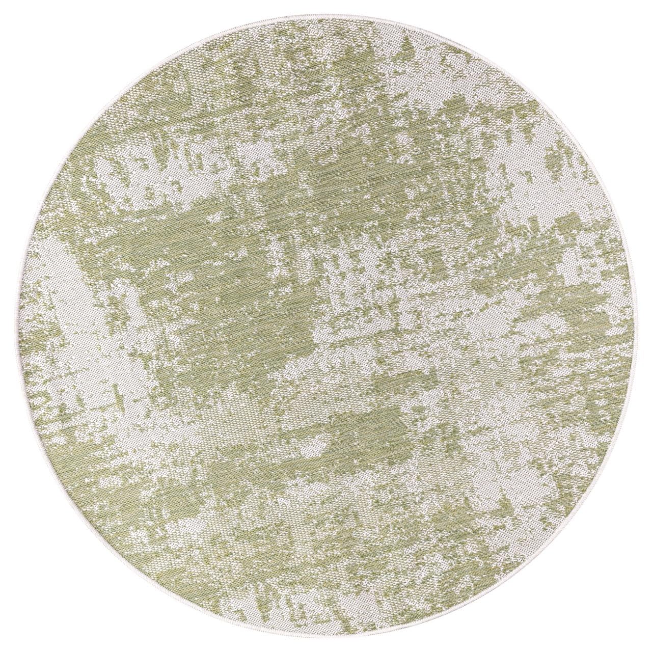 Green and ivory abstract rug in screened porch setting