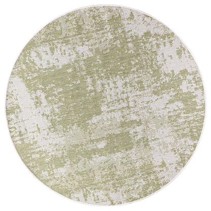 Green and ivory abstract rug in screened porch setting