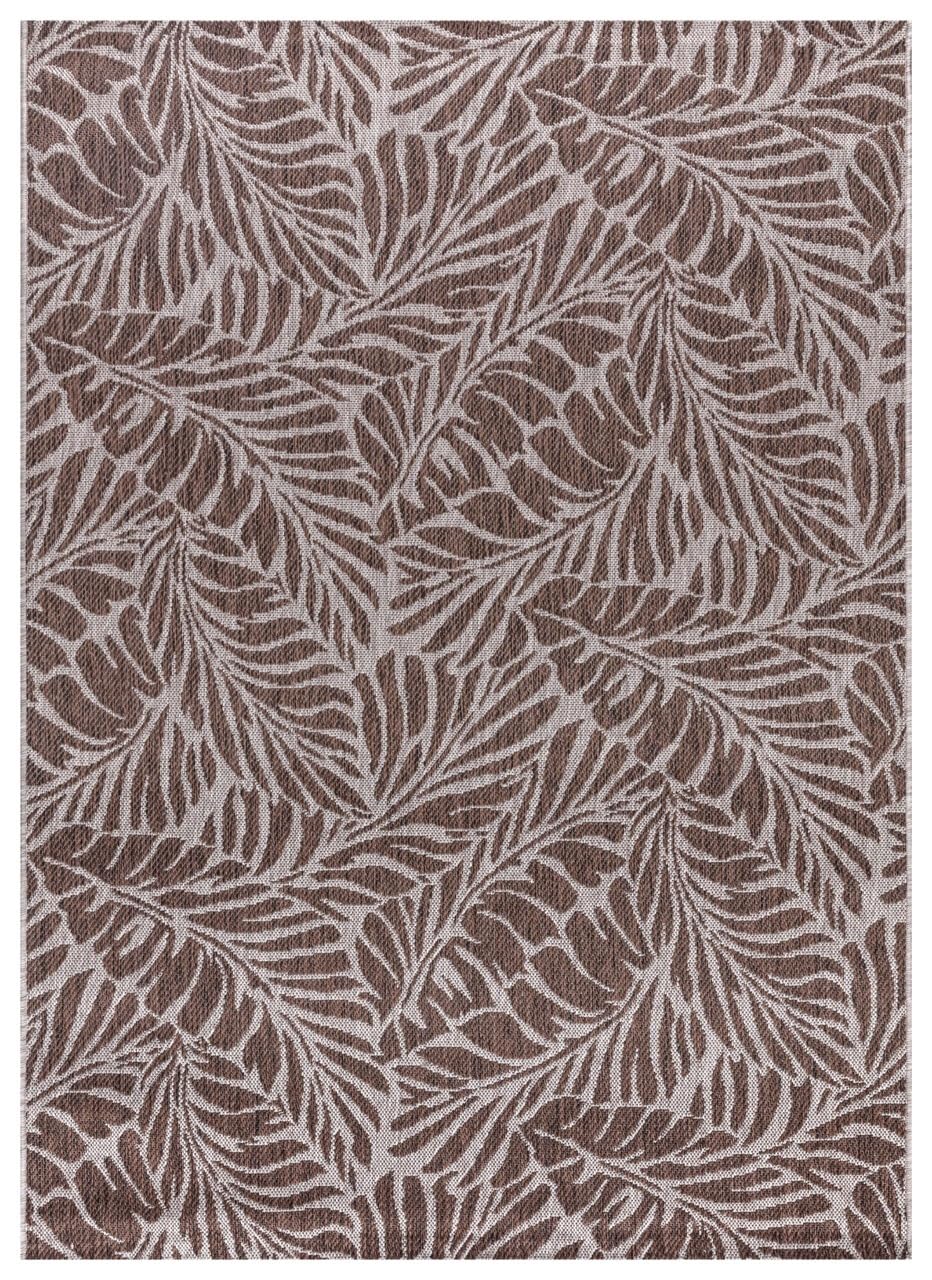 Brown and tan tropical leaf outdoor rug on covered teak patio