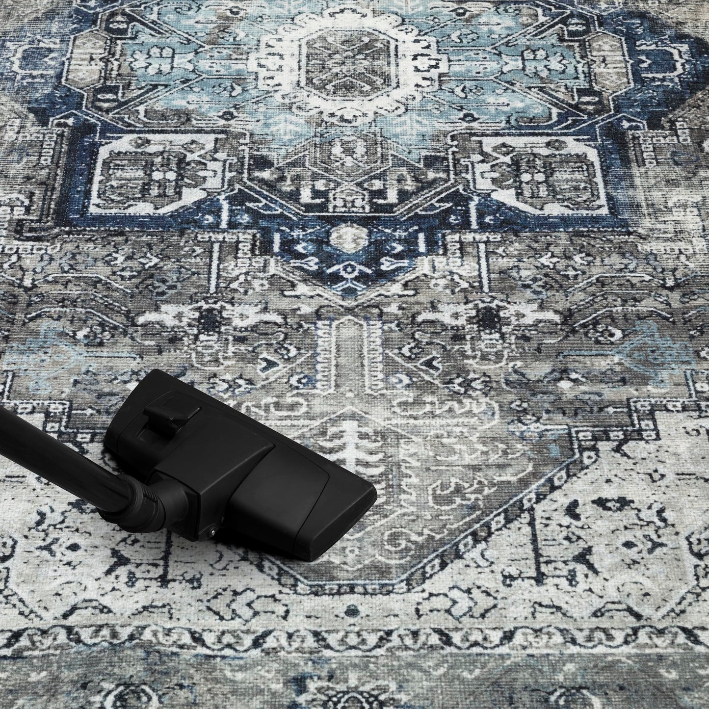 Faded gray Persian rug in a home library with leather chair