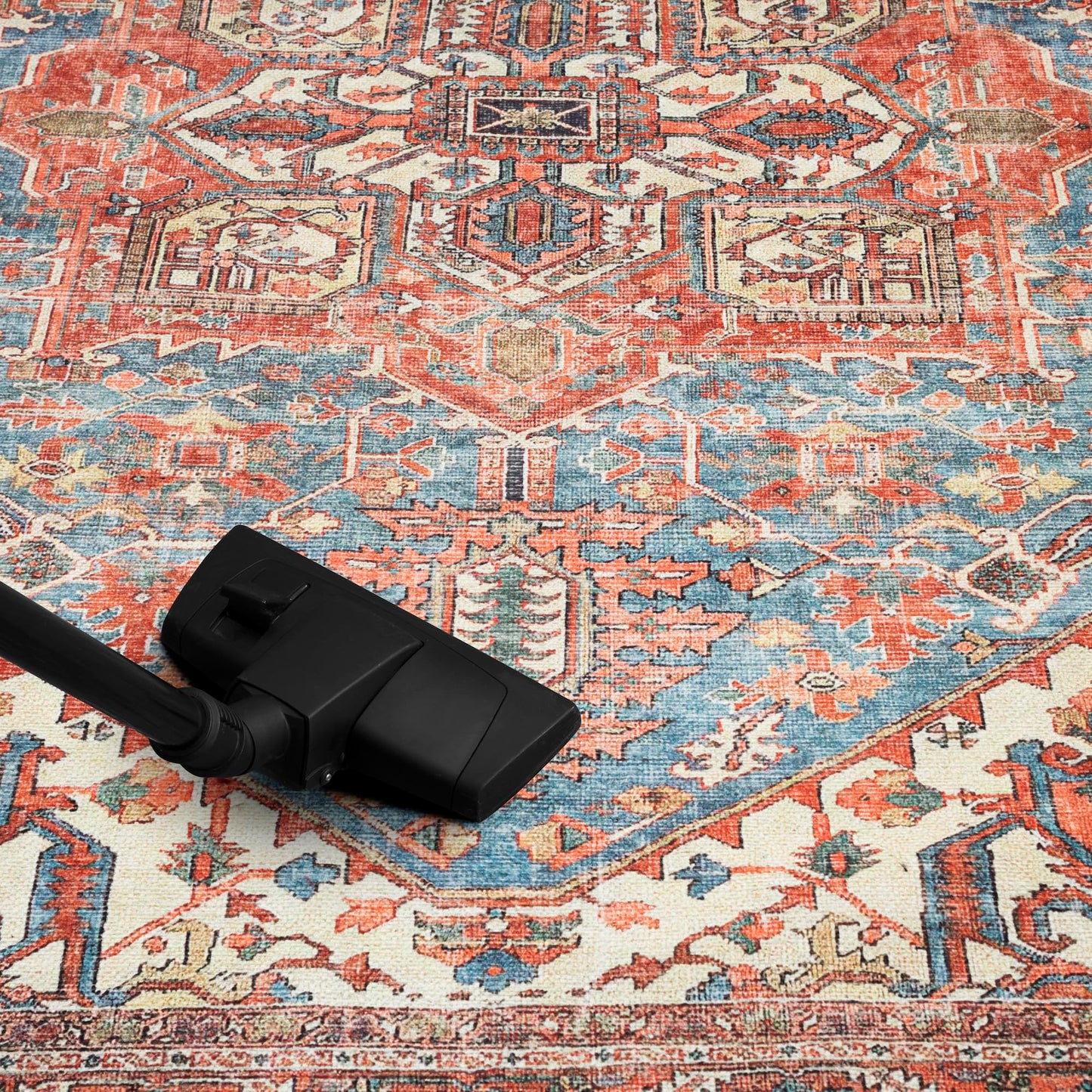 Reversed-color Heriz rug in a richly-styled home library