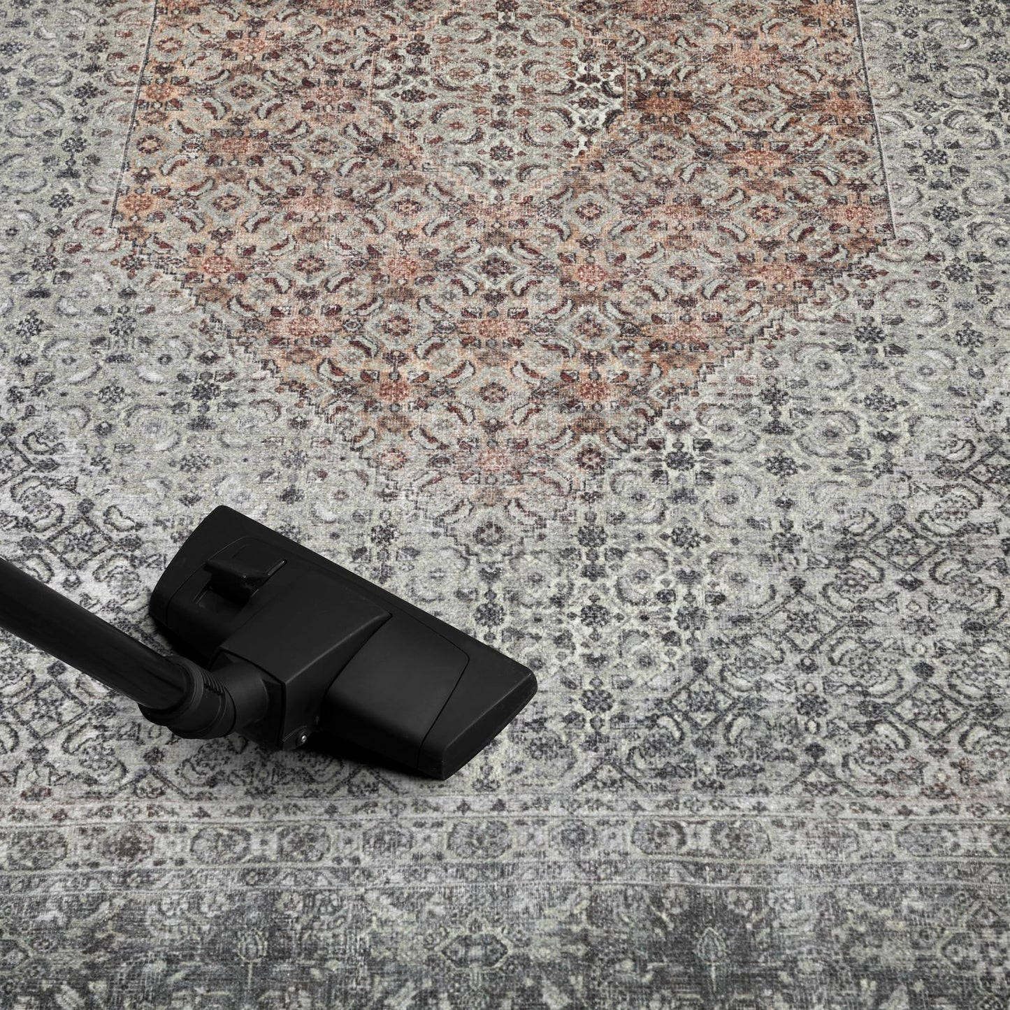 Refined Senneh rug in a home library with leather chair