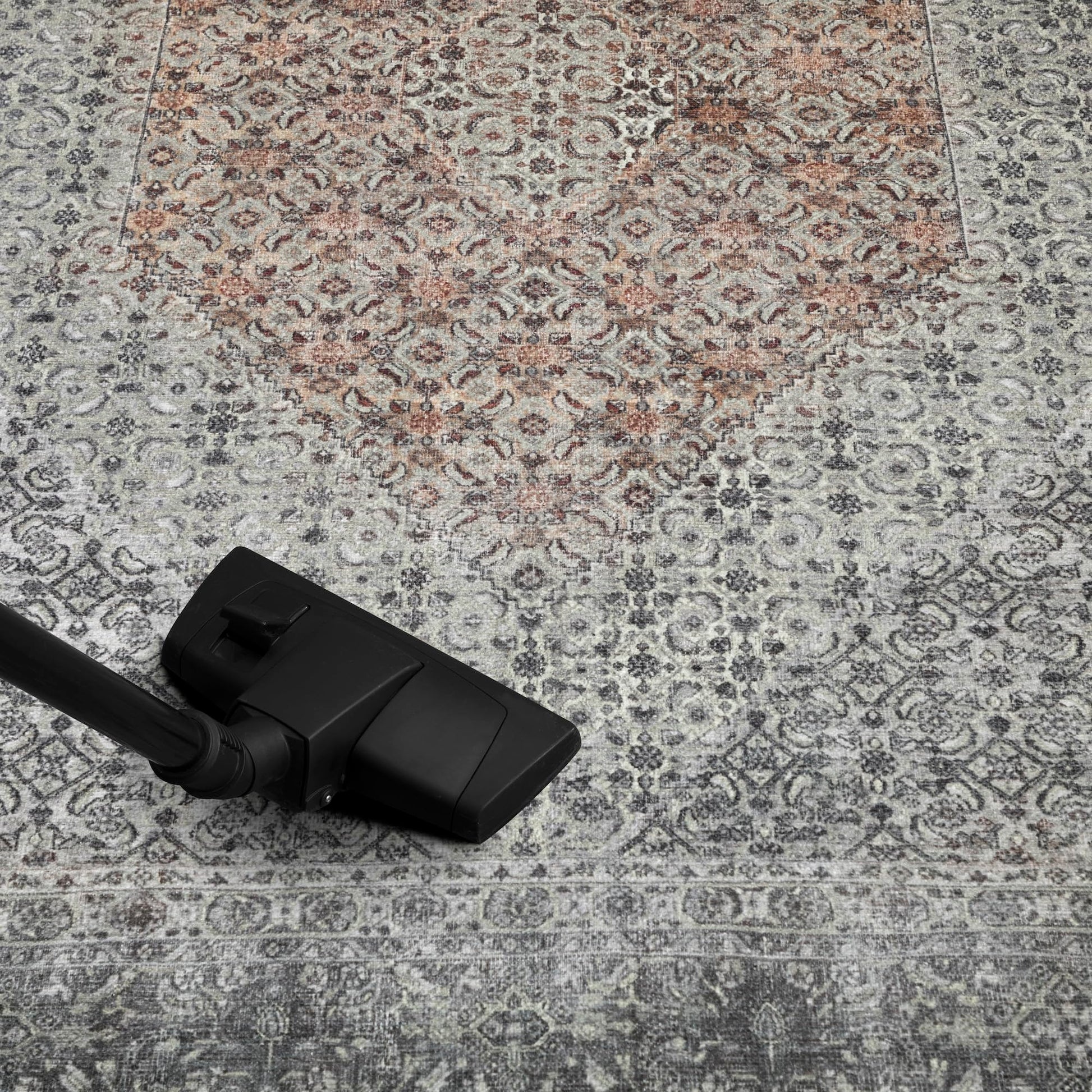 Refined Senneh rug in a home library with leather chair
