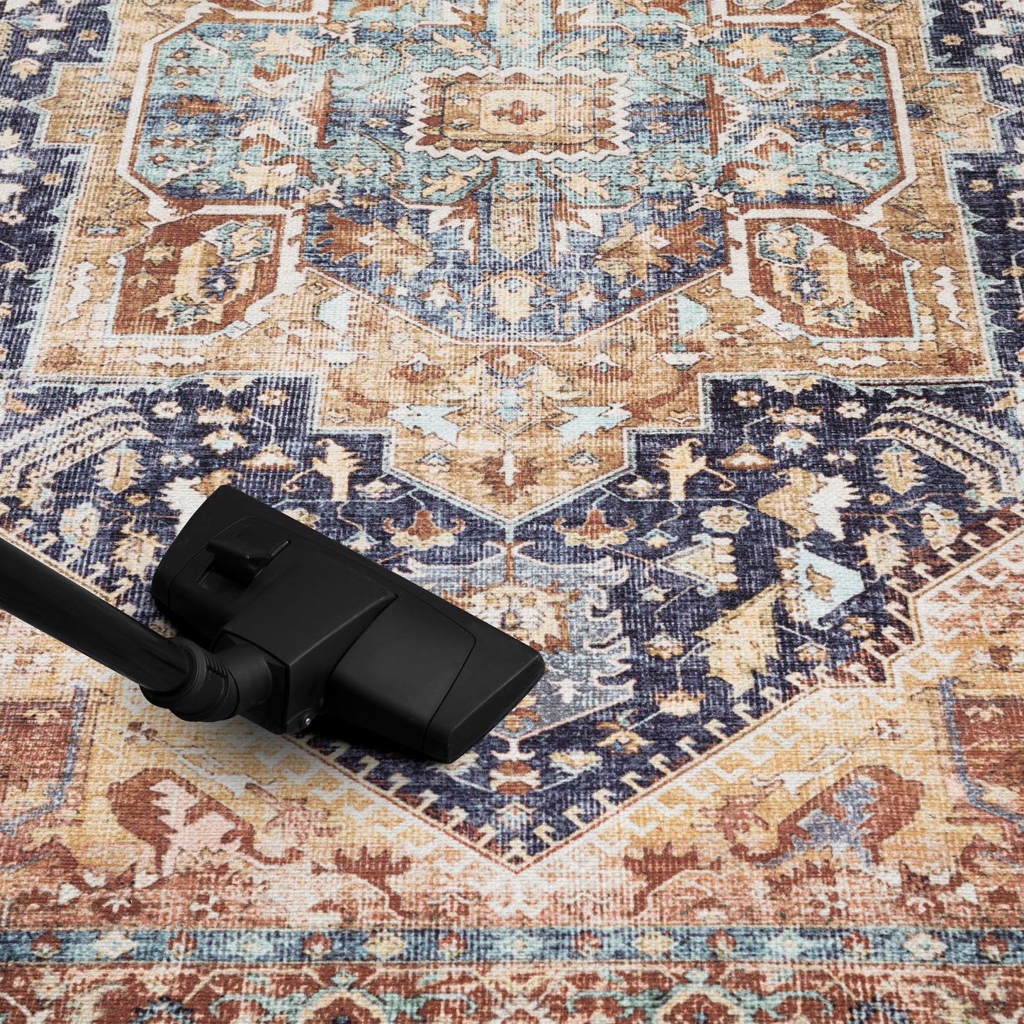 Navy and rust Heriz rug in a heritage library with leather chairs