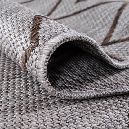 Brown Moroccan rug in three-season sunroom with rattan furniture