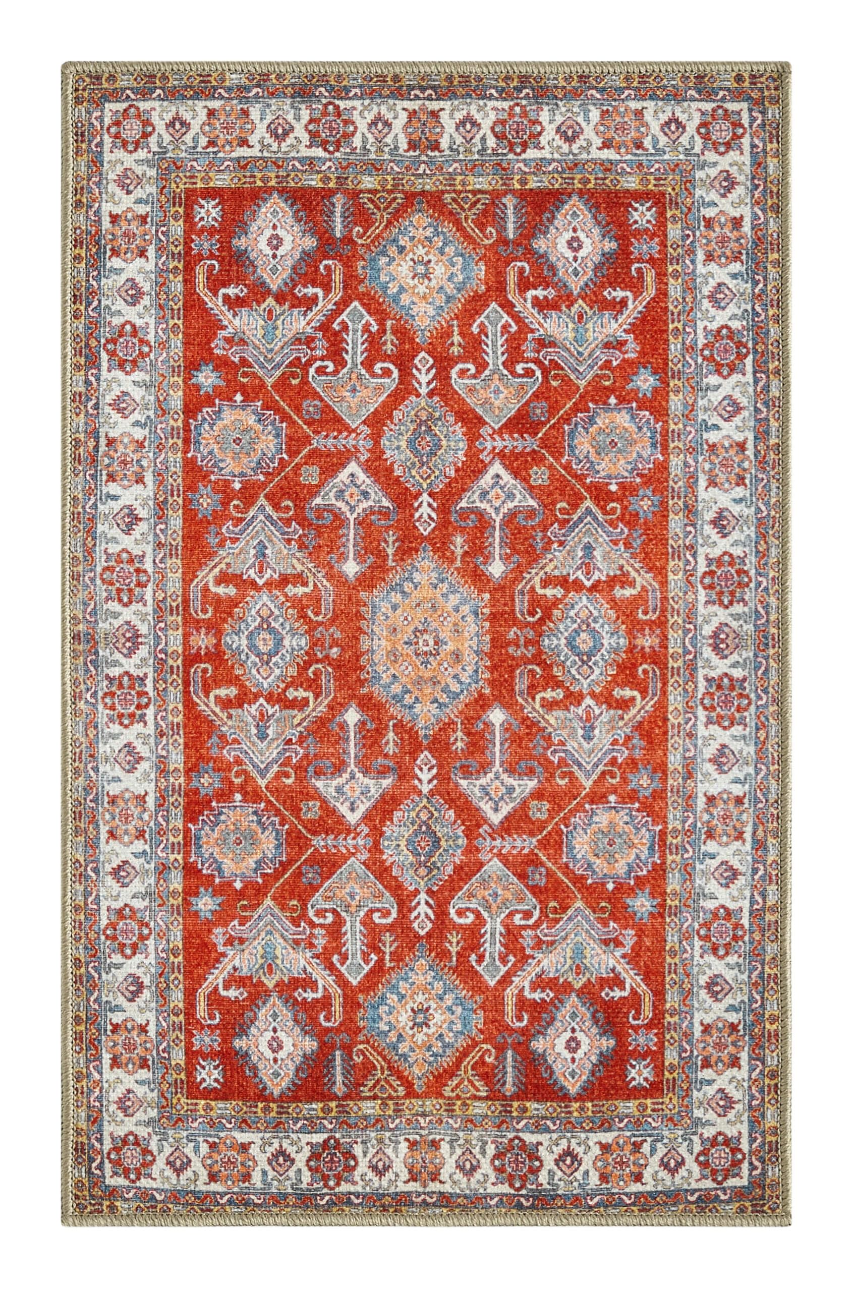 Bold Kazak rug in a designer dining room with rattan accents