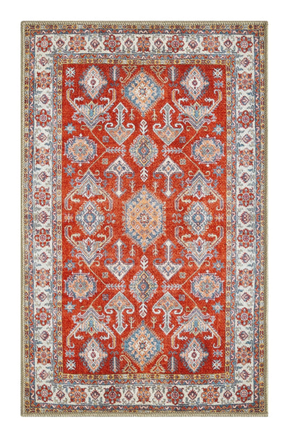 Bold Kazak rug in a designer dining room with rattan accents