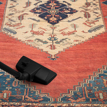 Tribal Hamadan rug in a collected home library with leather chairs