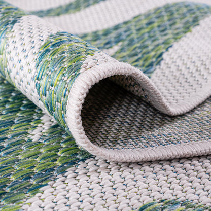 Green coral coastal rug in three-season sunroom with white furniture