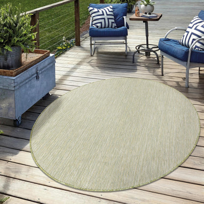 Solid green weatherproof rug on cedar deck with lounge chairs