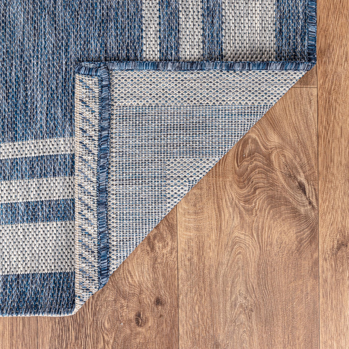 Bordered weatherproof rug beside swimming pool
