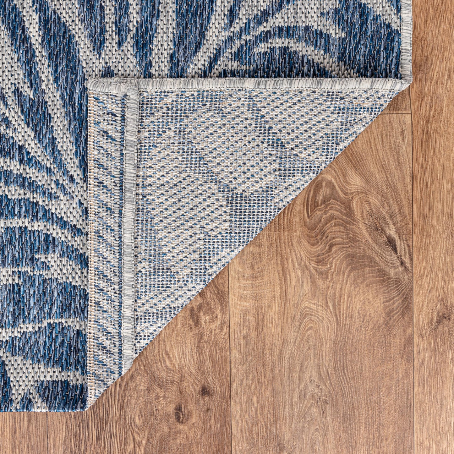 Tropical leaf weatherproof rug beside swimming pool