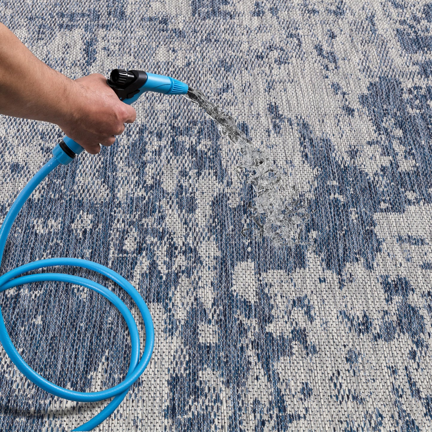 Navy abstract patio rug under bistro table with chairs