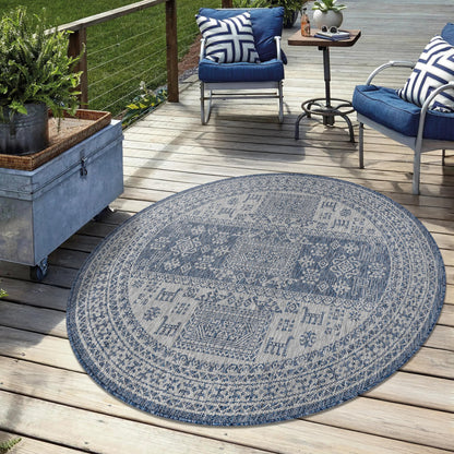 Navy weatherproof tribal rug on cedar deck with lounge chairs