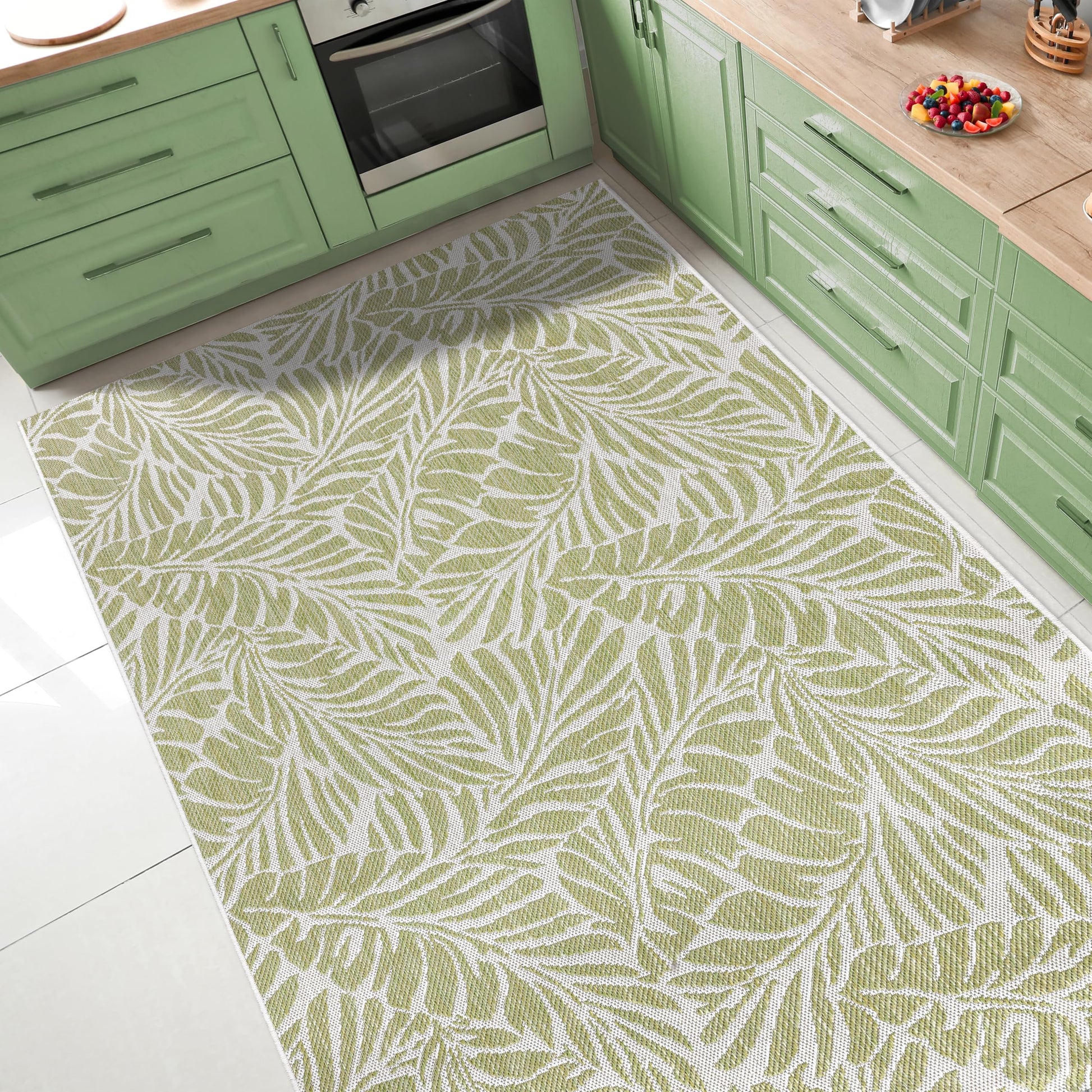 Tropical leaf outdoor rug under round patio dining table