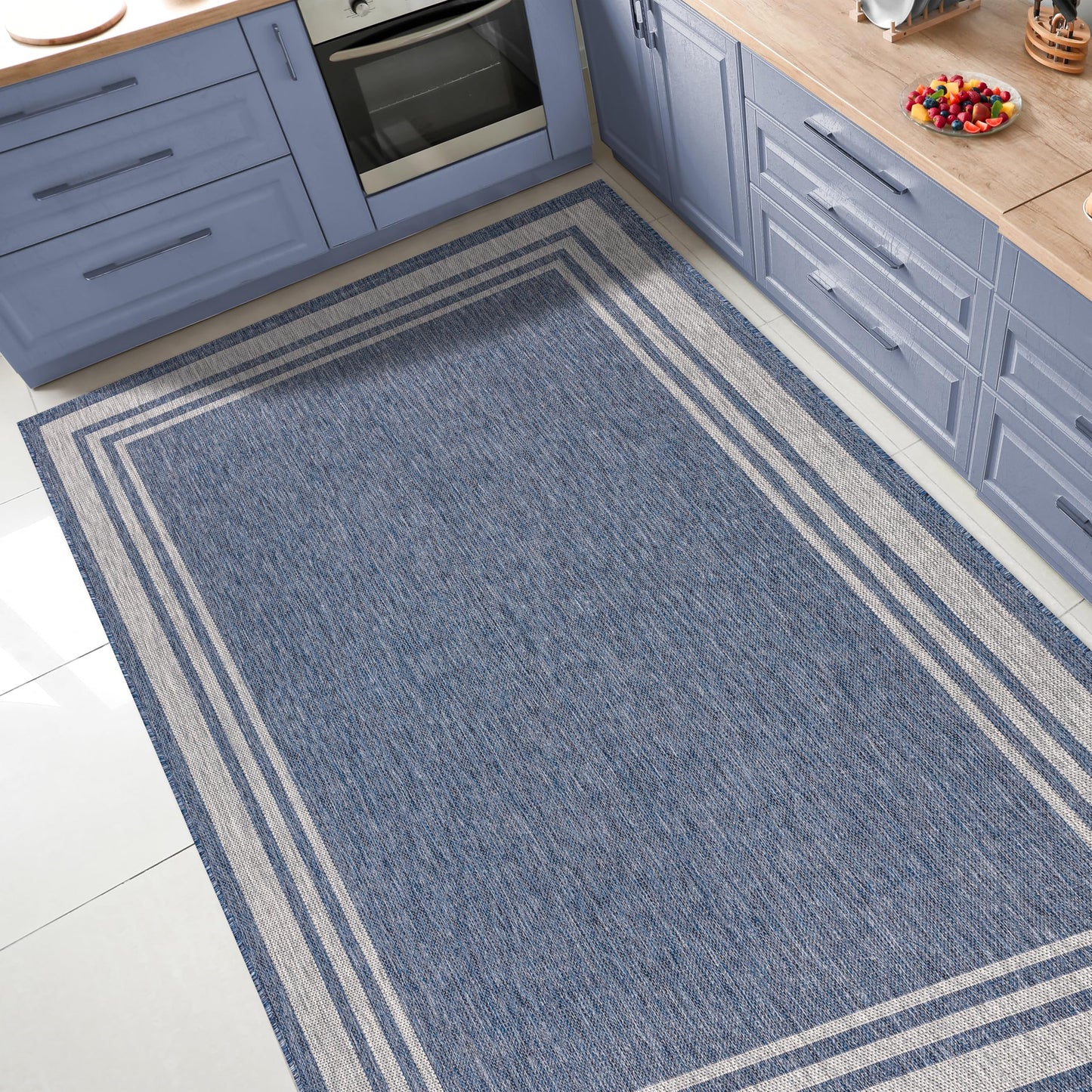 Bordered outdoor rug under round patio dining table