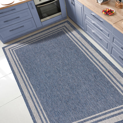 Bordered outdoor rug under round patio dining table