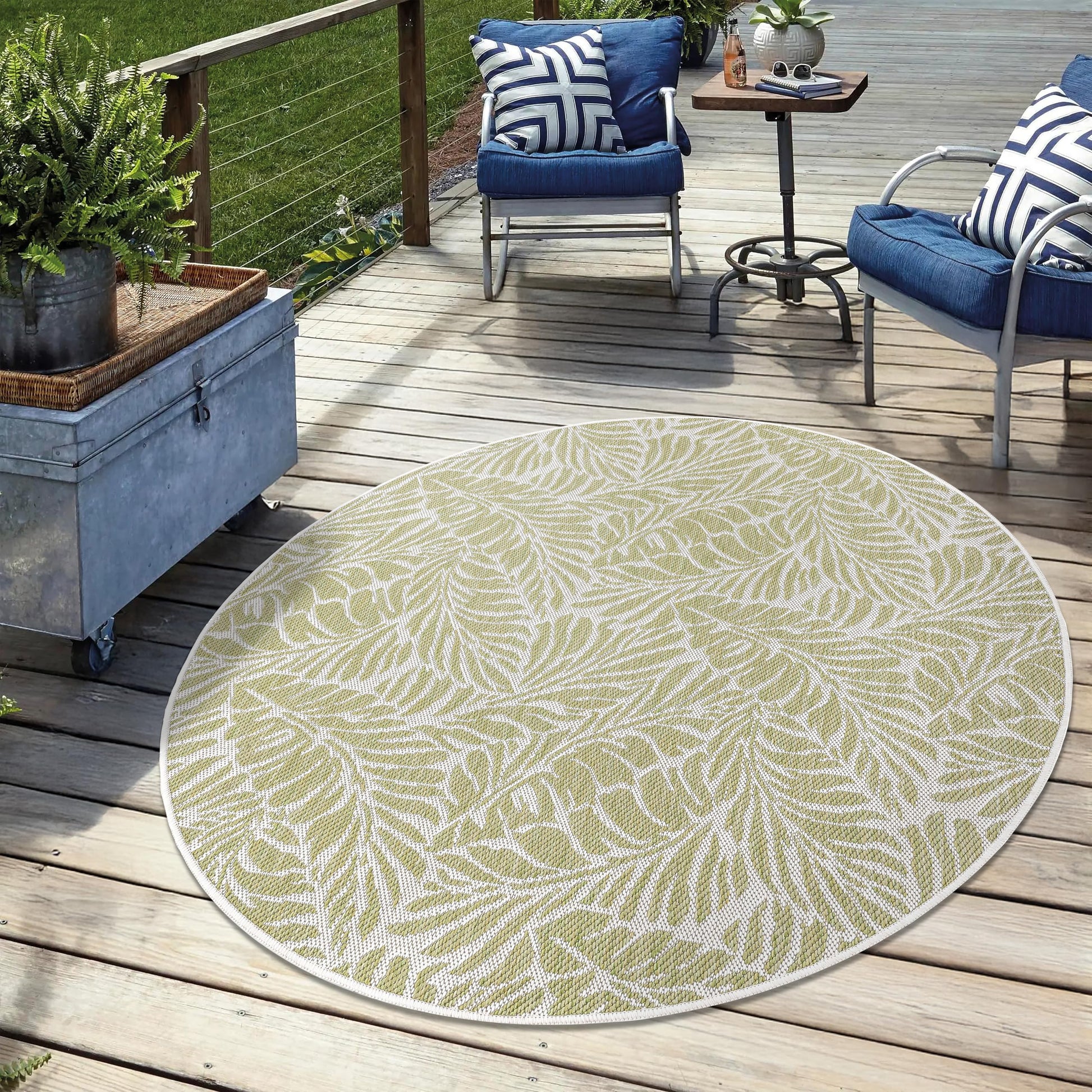 Green weatherproof botanical rug on cedar deck with lounge chairs
