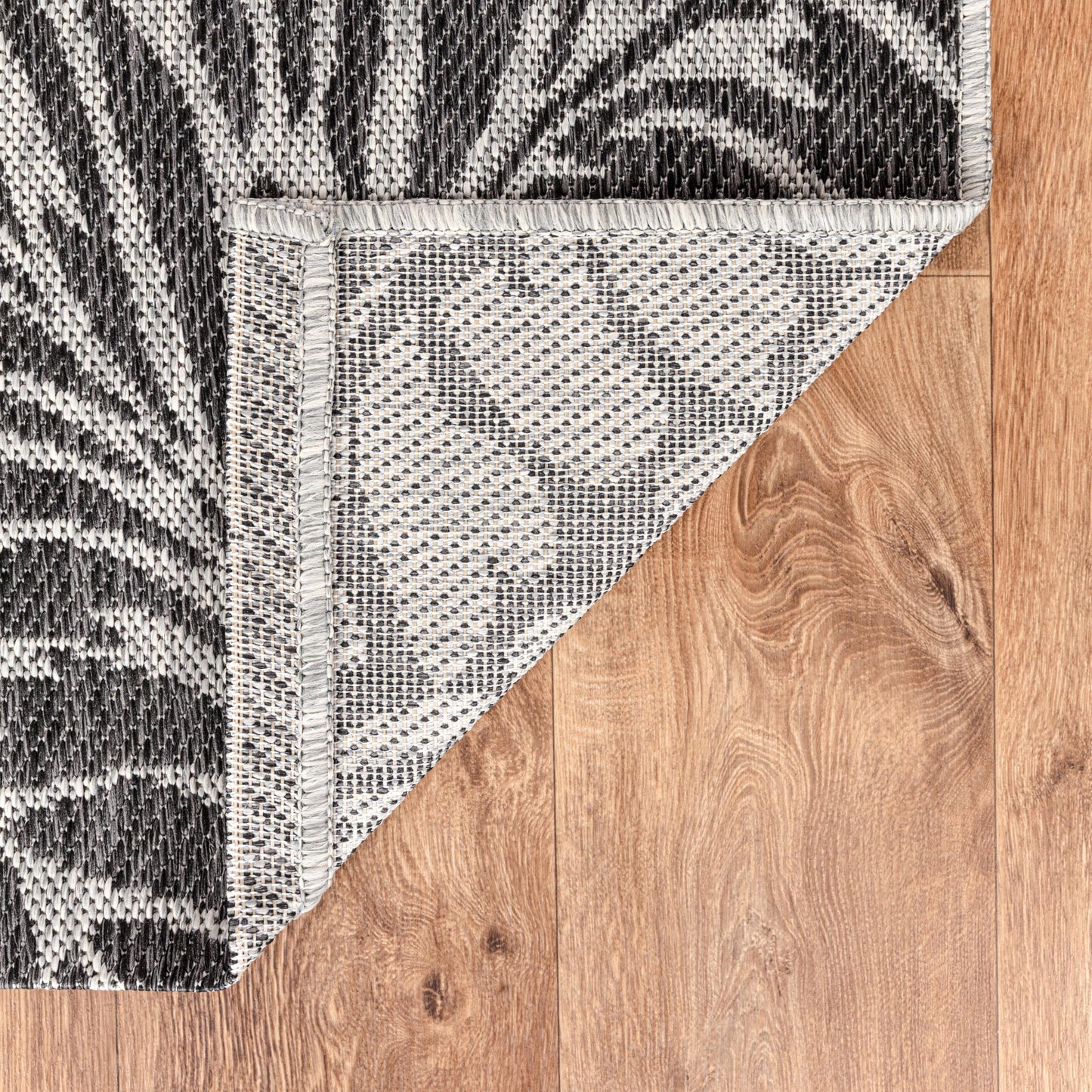 Tropical leaf weatherproof rug beside swimming pool