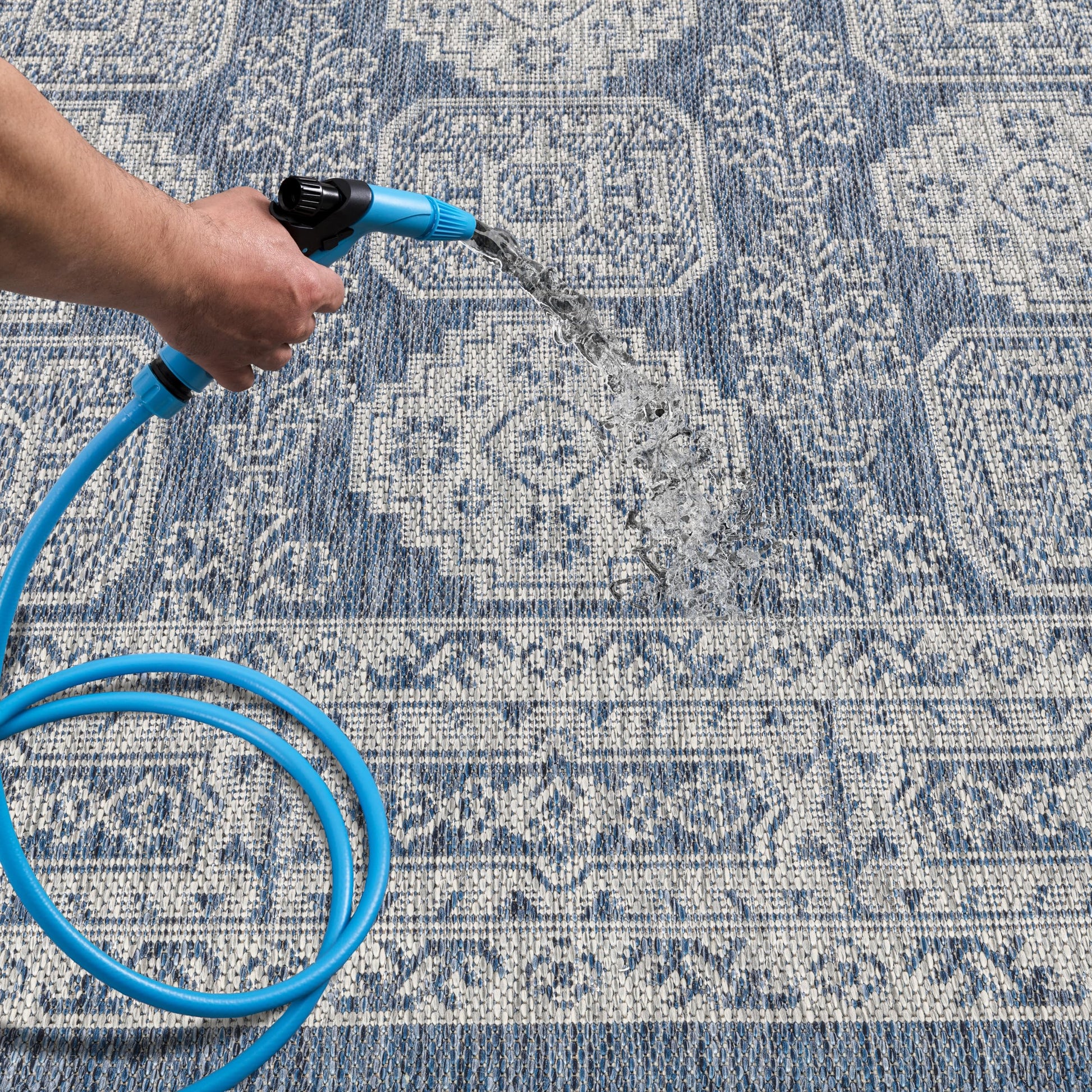 Navy Anatolian patio rug under bistro table with chairs