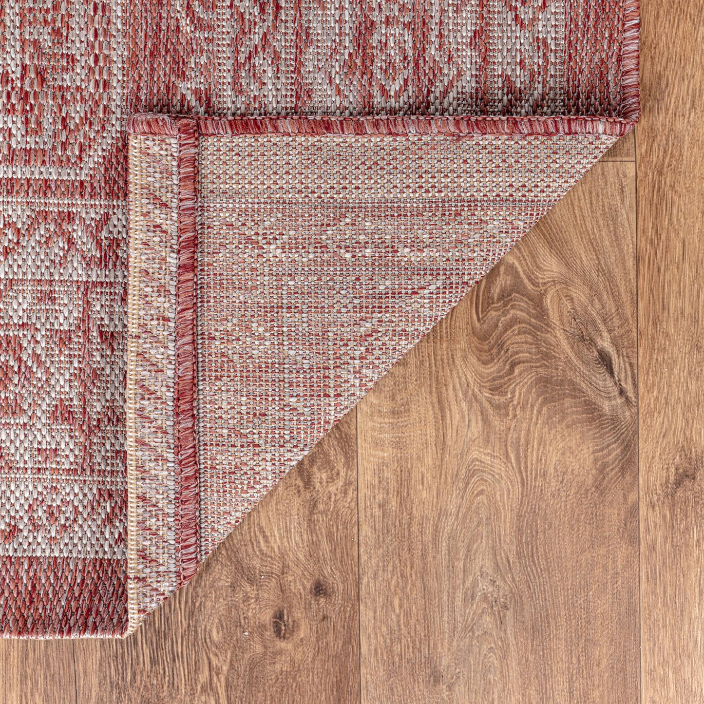 Terracotta Anatolian patio rug under bistro table with chairs