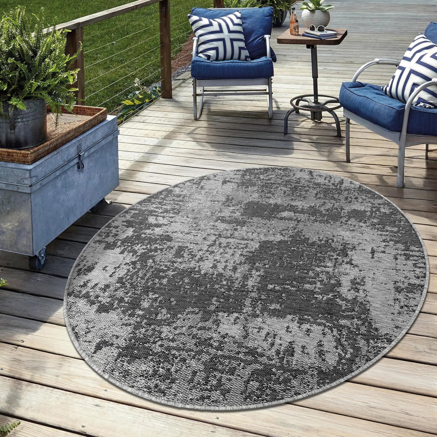 Black weatherproof rug on cedar deck with lounge chairs