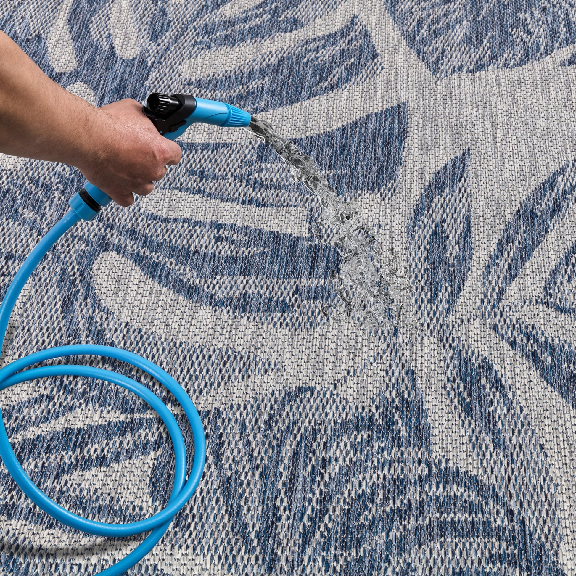 Navy jungle patio rug under bistro table with chairs