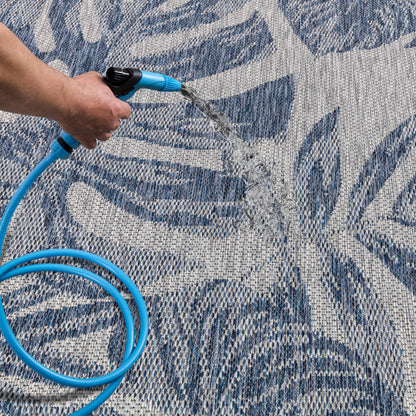 Navy jungle patio rug under bistro table with chairs