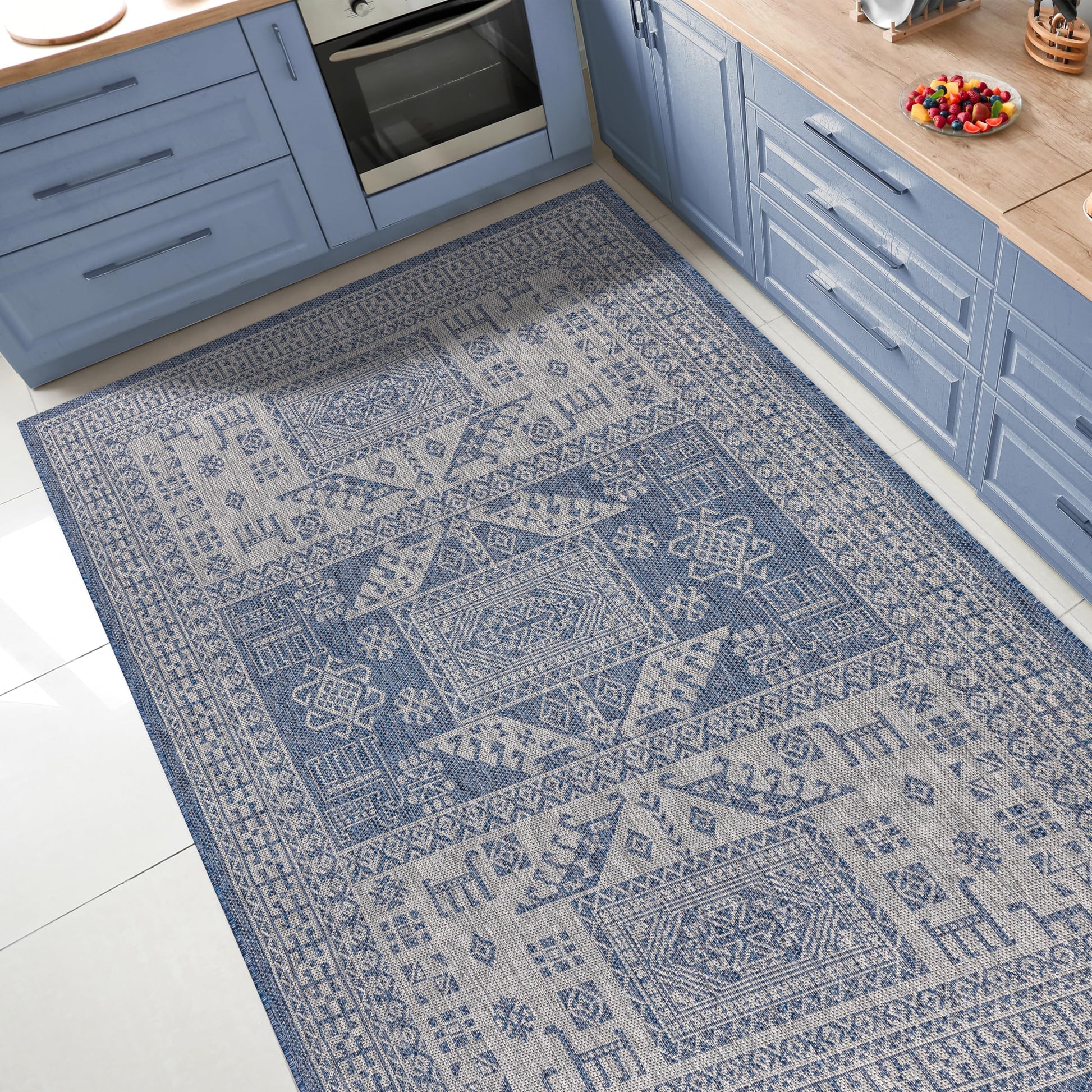 Tribal heritage outdoor rug under round patio dining table