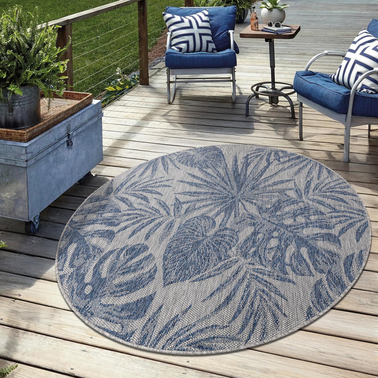 Navy weatherproof jungle rug on cedar deck with lounge chairs