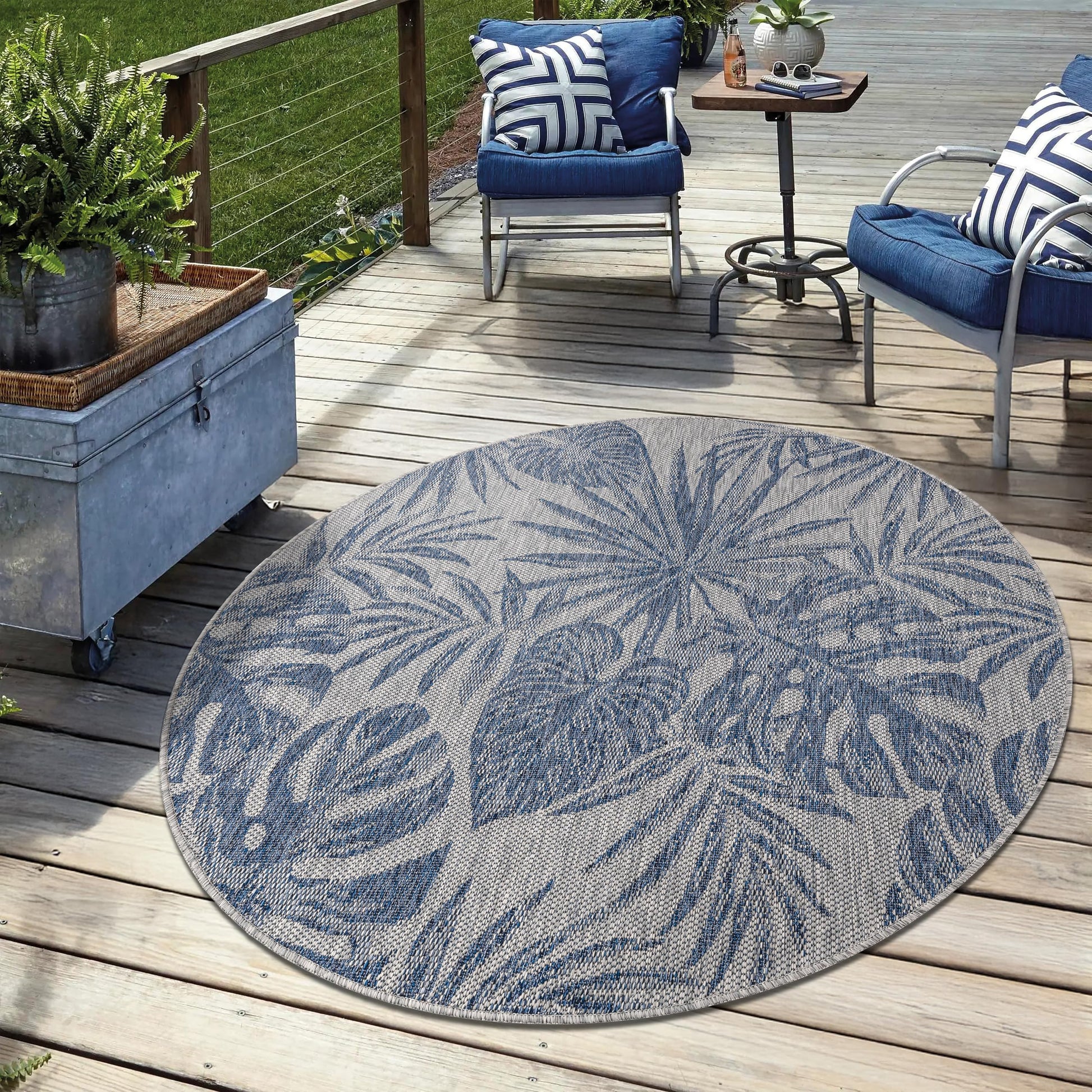 Navy weatherproof jungle rug on cedar deck with lounge chairs