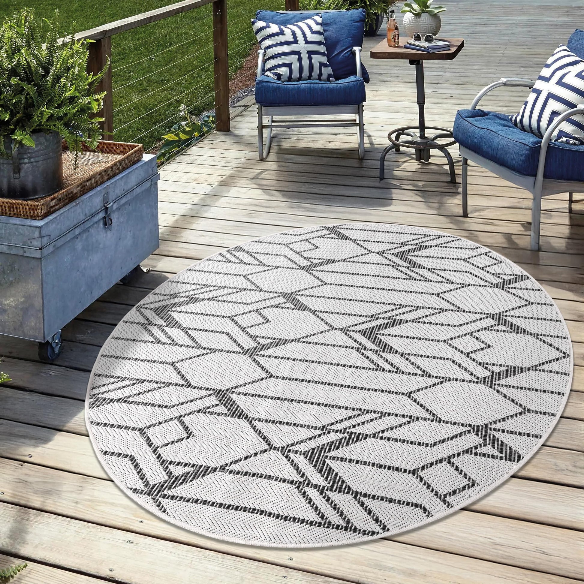 Black weatherproof Art Deco rug on cedar deck with modern lounge chairs