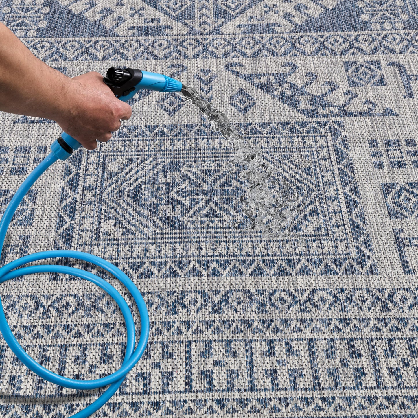 Navy tribal patio rug under bistro table with chairs