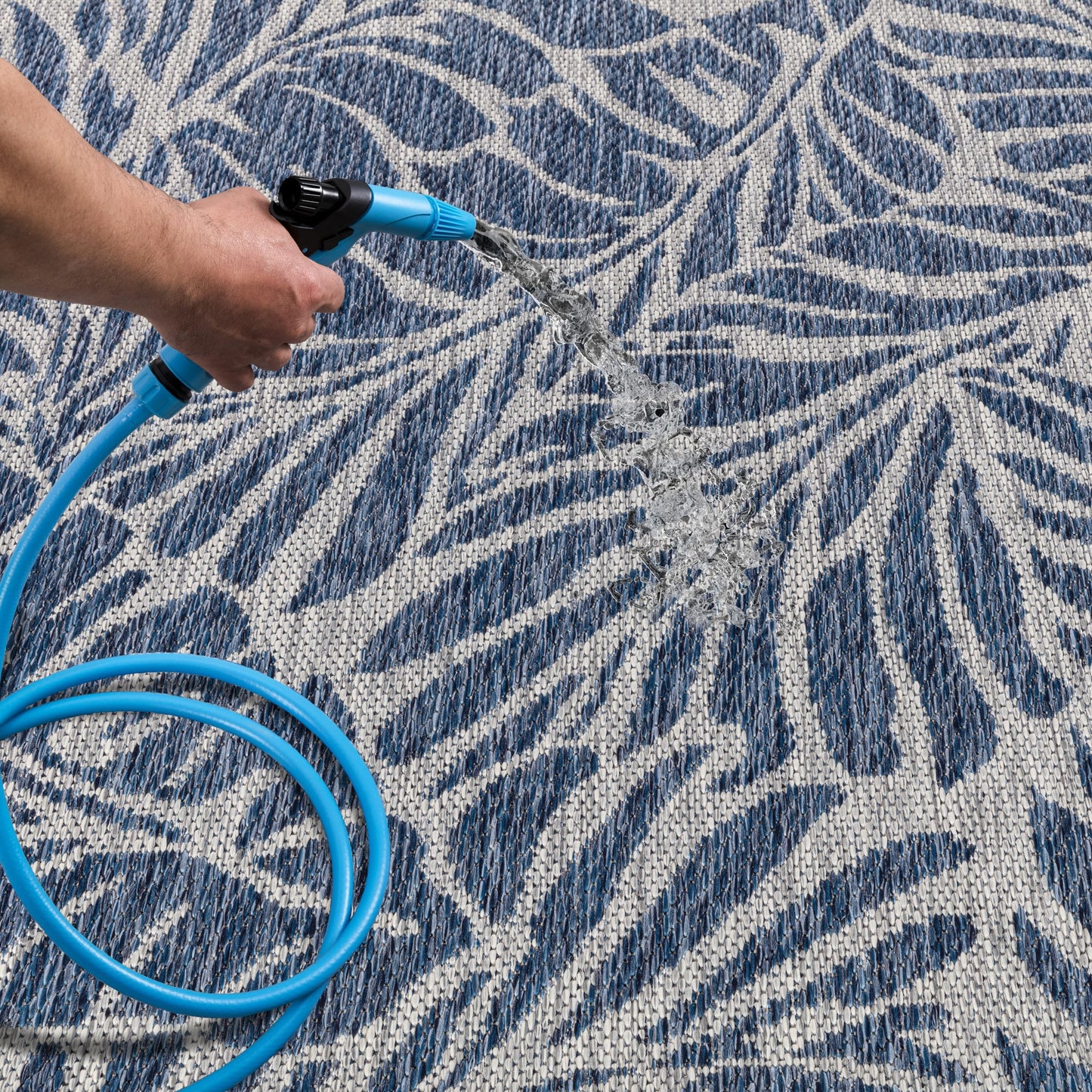 Navy botanical patio rug under bistro table with chairs
