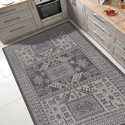 Tribal heritage outdoor rug under round patio dining table