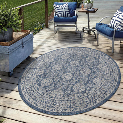 Navy weatherproof Anatolian rug on cedar deck with lounge chairs